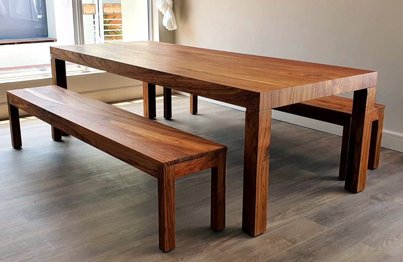 Eight-seater Maximus Dining Table hand-crafted in Kiaat timber. Pictured with 2 x 4-seater benches in Kiaat wood.